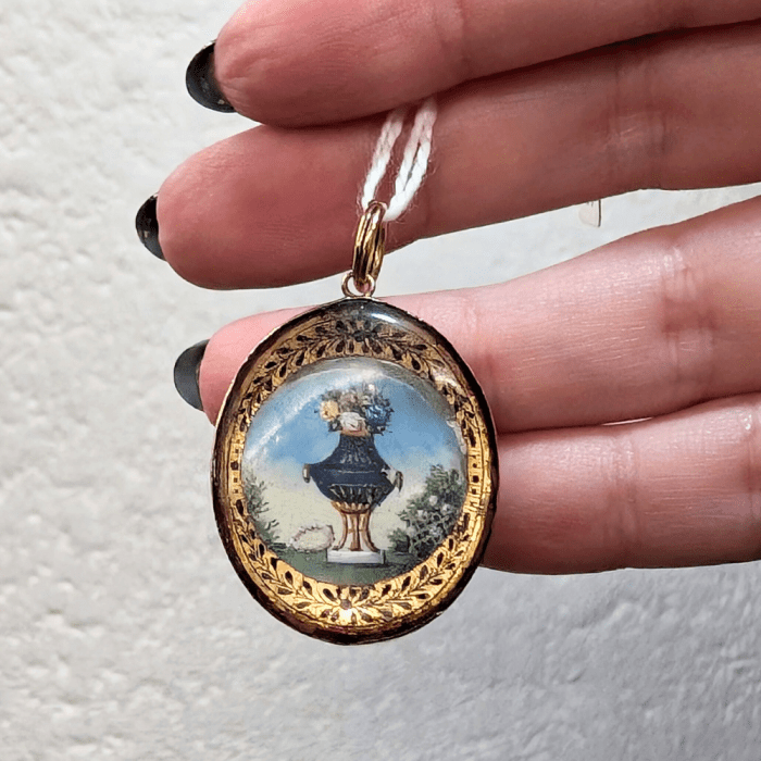 An unusual antique pendant with a floral design and hair on the reverse. From Pretty Different Shop, at NYCJAOS.