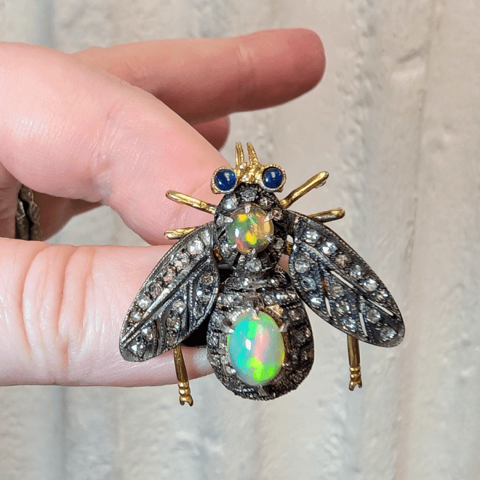 Articulated opal, sapphire, and diamond insect brooch, from J. Elizabeth Estate Jewelry.