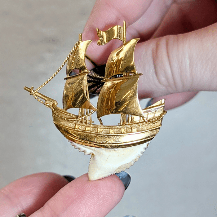This midcentury ship brooch has a hull made from a tiger's tooth. From Pretty Different Shop, at NYCJAOS Autumn 2025.