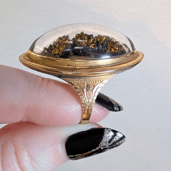 This unusual Victorian ring has a sample of the mineral Turgite under a rock crystal dome. From Marilyn & Co.