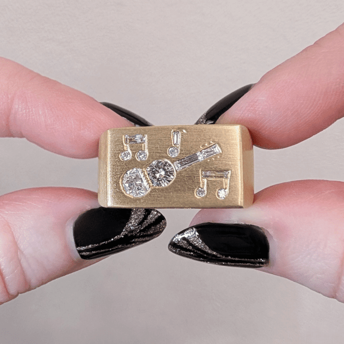 Vintage 1970's gold signet ring with diamond guitar and musical notes, from Circa 1700.