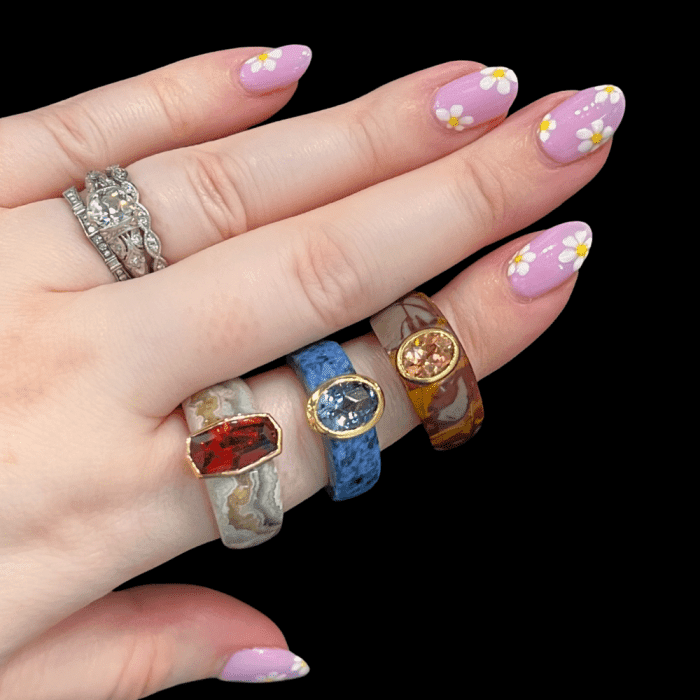 Mercurius Jewelry Cloak rings feature a solid band of carved hardstone lined in Fairmined gold and bezel set with a gemstone.