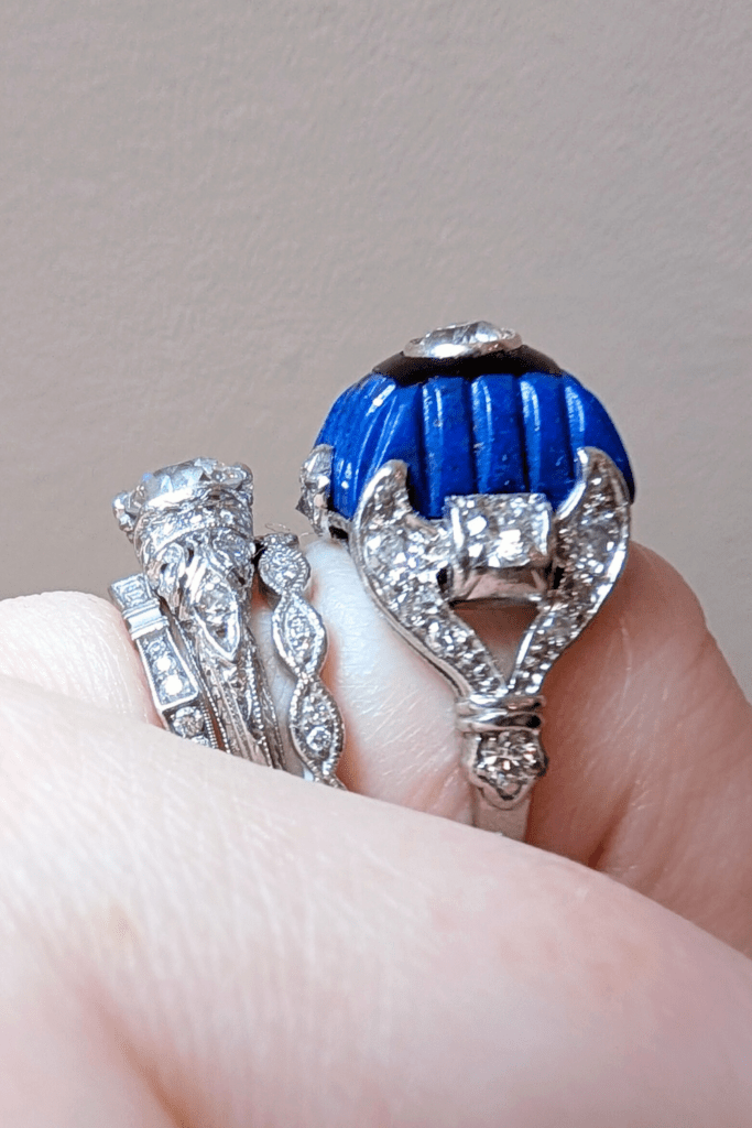 Art Deco diamond ring with carved lapis, onyx, and diamonds, side view on hand. From The Vintage Jeweller.