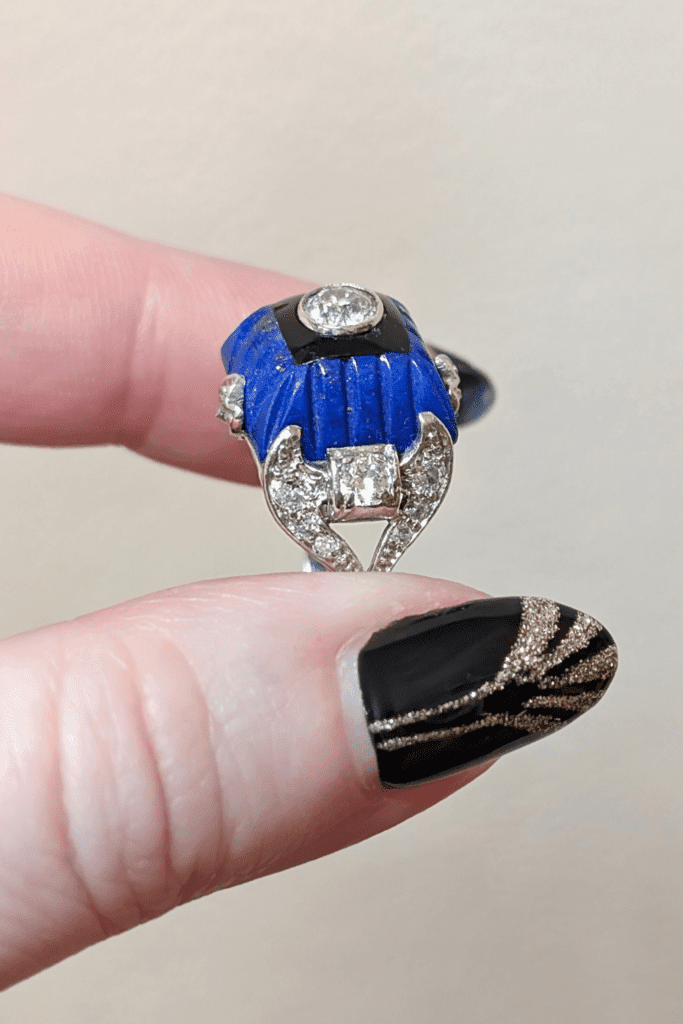 Art Deco diamond ring with carved lapis, onyx, and diamonds, tilted side view. From The Vintage Jeweller.