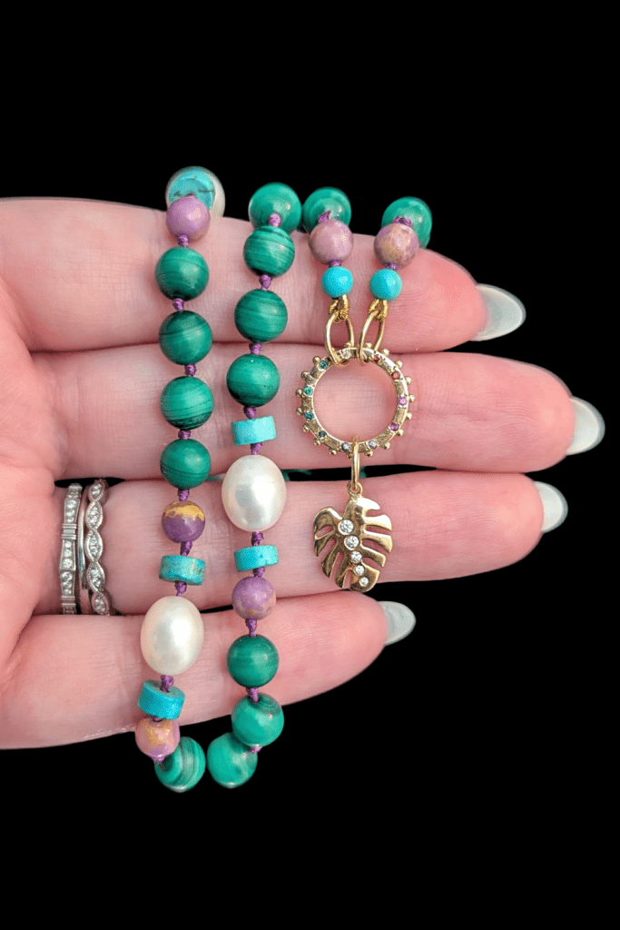 Delphine Leymarie Boheme Provence beads with rainbow charm holder connector and Monstera charm from Beaumont Jewelry Collective.