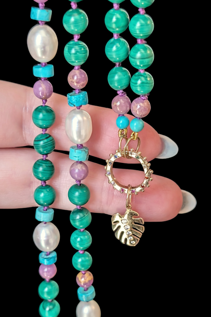 Delphine Leymarie Boheme Provence beads with rainbow charm holder connector and gold Monstera charm from Beaumont Jewelry Collective