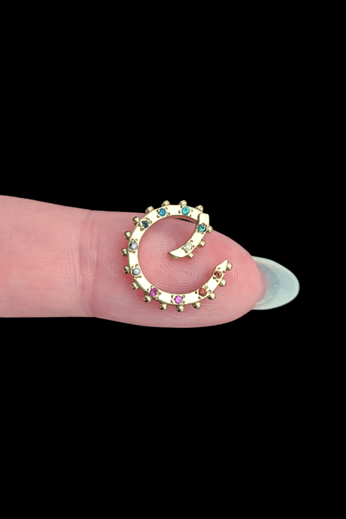 Delphine Leymarie rainbow clicker charm holder connector in 14K yellow gold, open, from Beaumont Jewelry Collective.