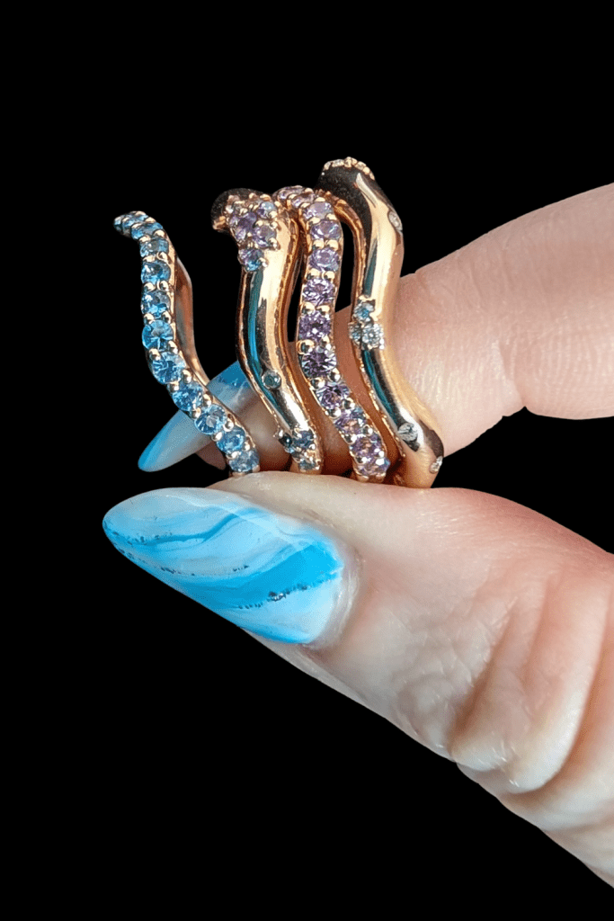 Dylann Wolfe Shimmering Tides stacking rings in Fairmined gold with sapphires and recycled diamonds. From Beaumont Jewelry Collective.
