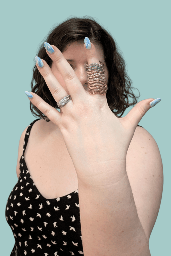Wearing Dylann Wolfe Long Lull and Shimmering Tides rings in Fairmined gold from Beaumont Jewelry Collective.
