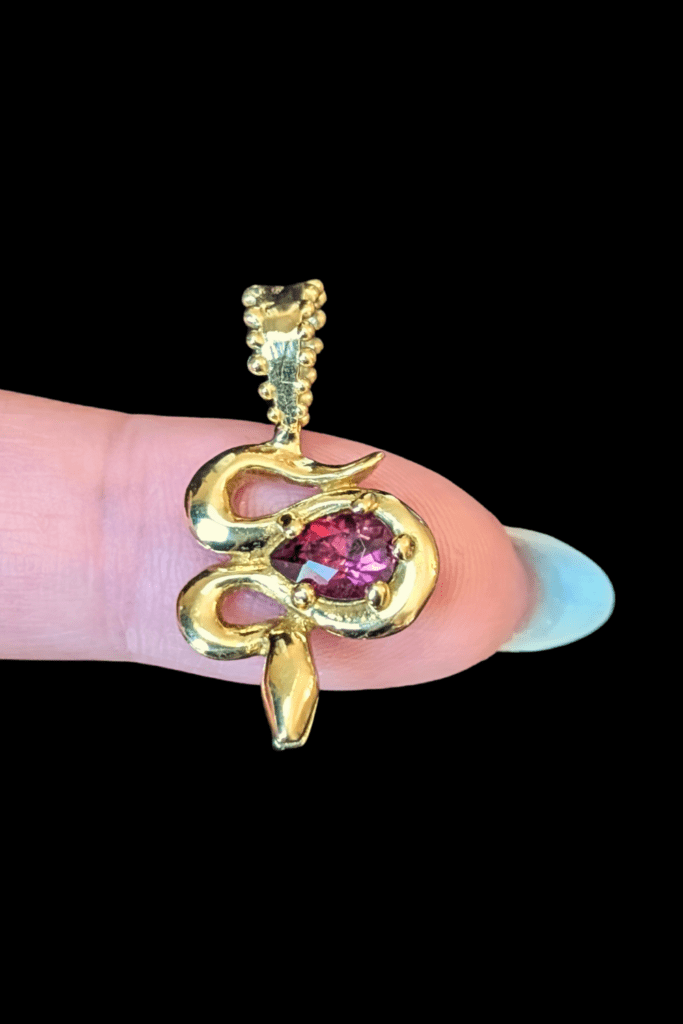 Delphine Leymarie garnet snake charm in 14K yellow gold from Beaumont Jewelry Collective