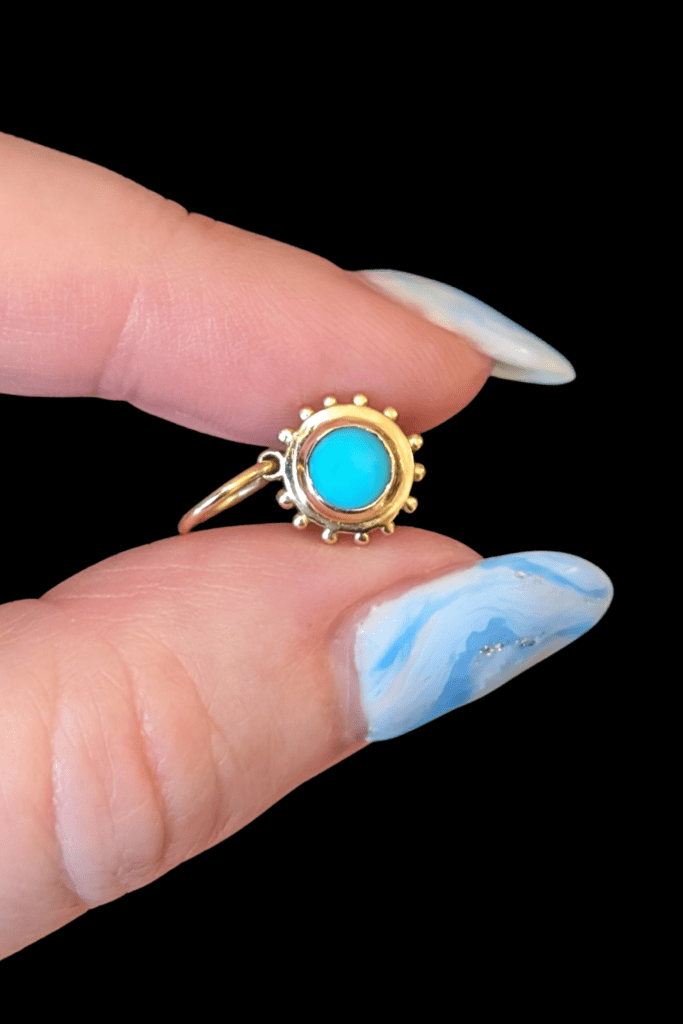 Delphine Leymarie turquoise soleil charm in 14K yellow gold from Beaumont Jewelry Collective.
