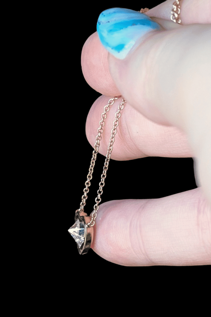 WEND Rebelheart Antique Reverse Set Diamond Necklace in recycled yellow gold from Beaumont Jewelry Collective; side view.