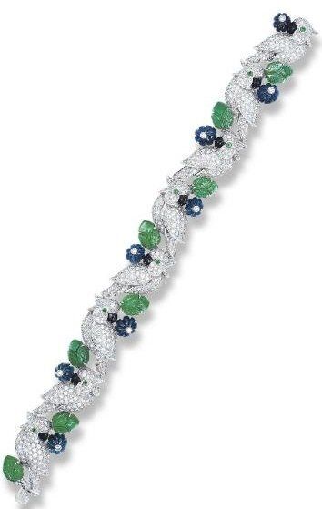 Cartier diamond, emerald, and sapphire bird bracelet.  Via Diamonds in the Library.