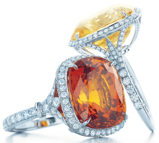 Two gemstone and diamond rings by Tiffany & Co.; one with a yellow sapphire and one with an orange sapphire. From the 2013 Tiffany & Co. Blue Book Collection. Via Diamonds in the Library.