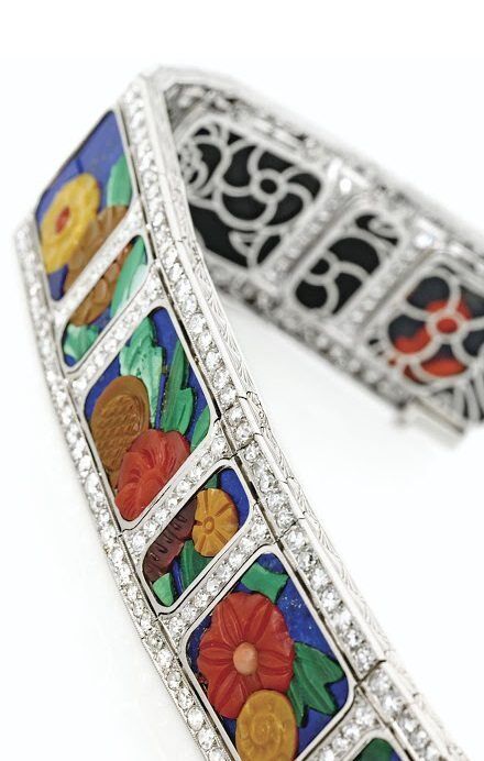 An Art Deco carved hardstone and diamond bracelet with diamonds, coral, carnelian, chalcedony, malachite and lapis lazuli. Circa 1925.