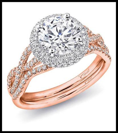 This Coast diamond rose gold engagement ring features a twisted splint shank design and a white gold diamond halo around the 1.5 carat center stone. Shown with matching band. Via Diamonds in the Library. 