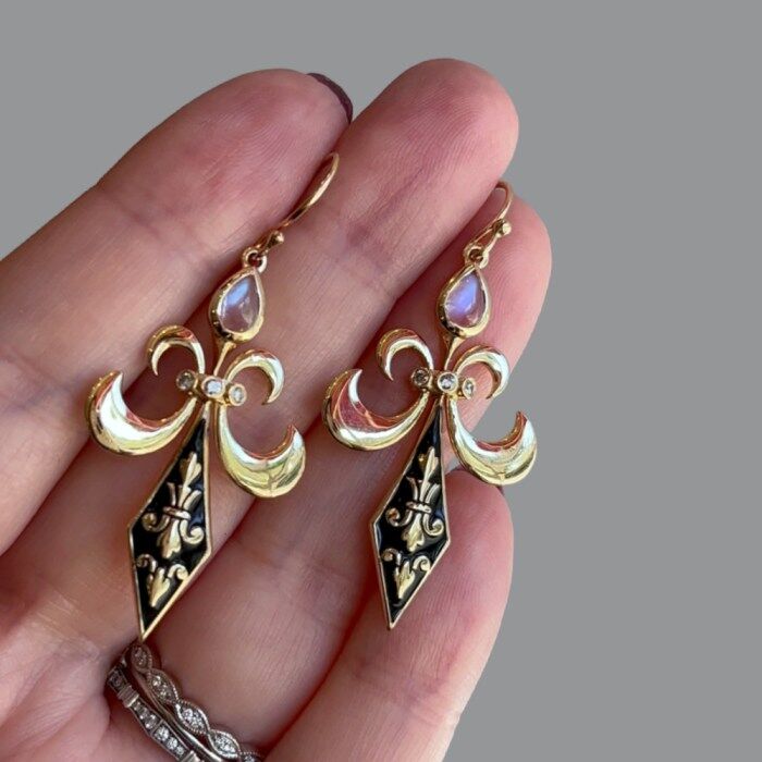 The Lily Fleur de Lis earrings from Loriann Jewelry's Modern Renaissance collection. Black enamel, diamond, and moonstone earrings in gold.