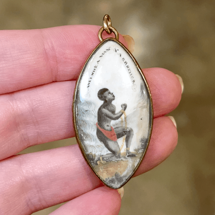 An exquisite example of abolitionist jewelry, this pendant features a miniature inspired by the Wedgewood anti-slavery medallion. From Sandy Jacobs Antiques.