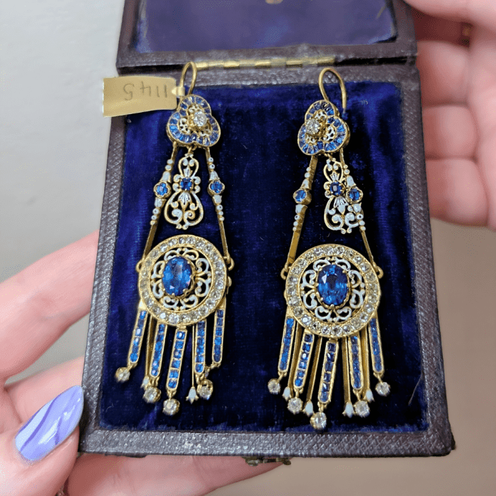 Stunning antique white enamel and sapphire earrings in box from Ishy Antiques, seen at NYCJOAS Spring 2025