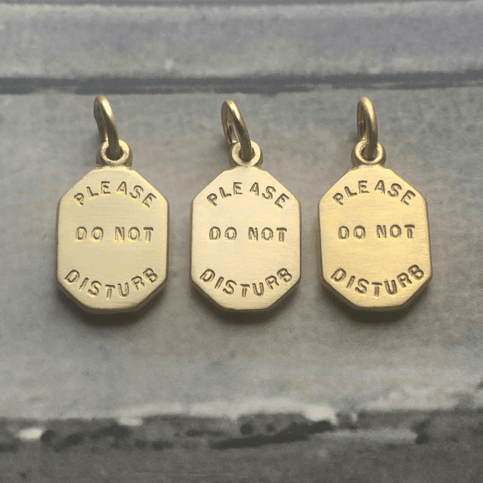 Please do not disturb necklace pendants in yellow gold by Black Umbrella Jewelry.