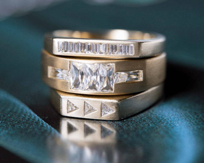 Three yellow gold and diamond band rings by Lindley Gray in the modern Art Deco style.