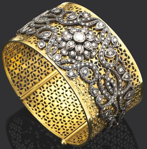 Pierced yellow gold cuff bracelet accented with a floral design in silver and diamonds. Via Diamonds in the Library.