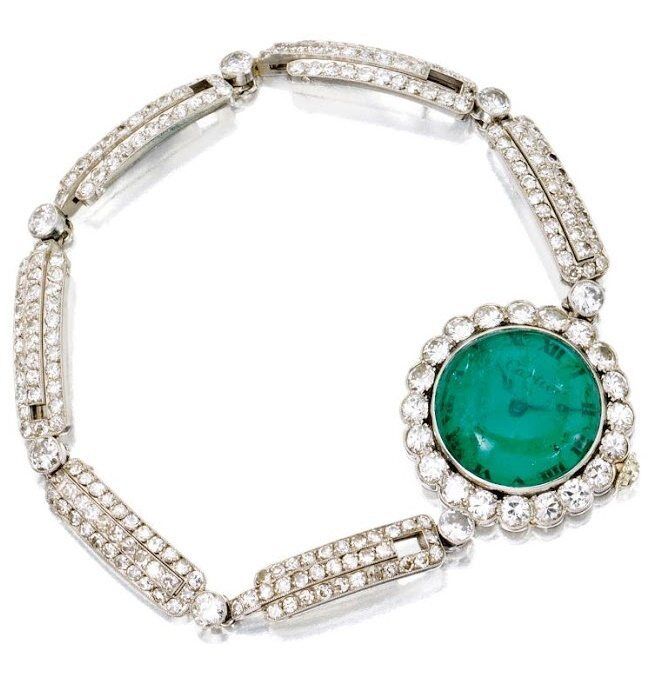 Art Deco emerald and diamond wristwatch, Cartier. Via Diamonds in the Library.