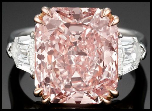 7.09 carat type IIa fancy pink diamond flanked on either side by two shield or bullet-cut diamonds, totaling 1.04 carats and both graded E color and VS1 clarity. Via Diamonds in the Library.