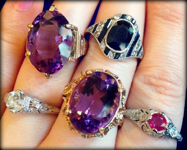 A handful of gemstone rings - Art Deco, retro, and contemporary; sapphires, amethysts, and a ruby - at The Antique Guild. Via Diamonds in the Library.