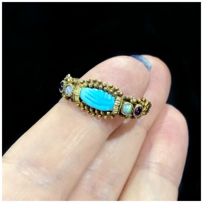 An extremely rare antique fede ring in gold, featuring gems and a carved turquoise pair of hands. From The Spare Room Antiques.