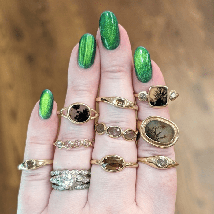 Dendritic agate and brown diamond rings from Taste of Honey NYC, seen at NYCJAOS 2025.