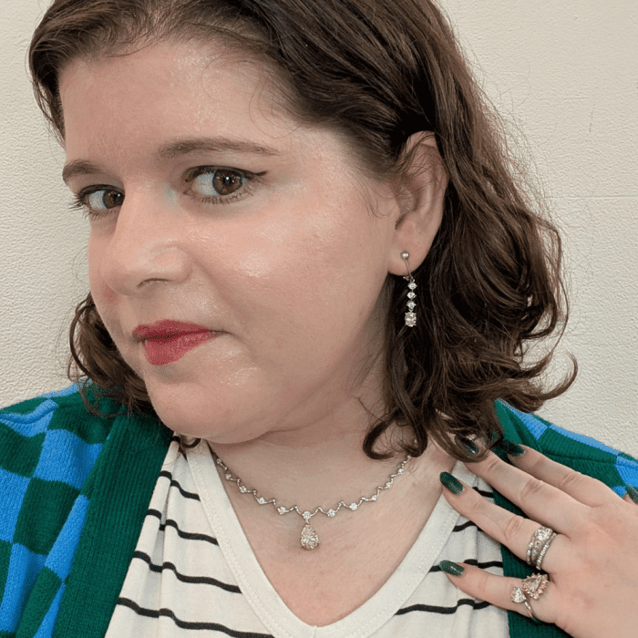 Wearing a full suite of Ariis Jewelry's diamonds - a pear diamond necklace, diamond earrings, and a pinky ring at Spring NYCJAOS 2026.